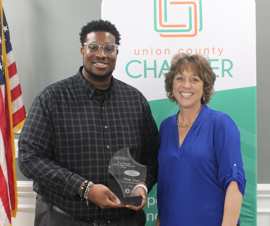 Philli[p Faust receives Sales Award from Dr. Maria Pharr