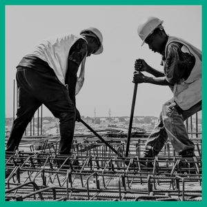 two men working on construction of a building