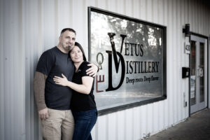 Exterior of Vetus Distillery with owners 