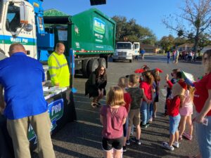 Waste Pro employees talking to children