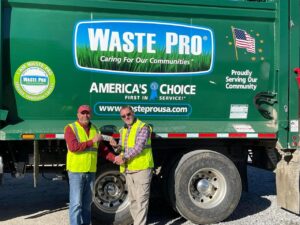Waste Pro Truck with two workers in front.